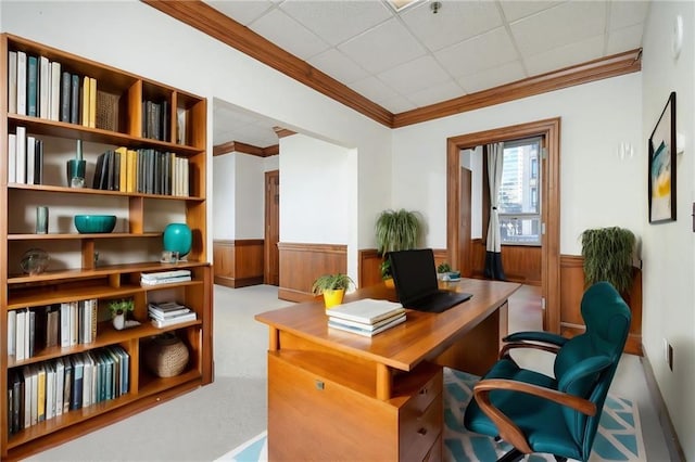 office area featuring a wainscoted wall, a drop ceiling, and crown molding