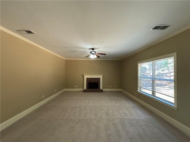 unfurnished living room with light carpet, crown molding, ceiling fan, and a brick fireplace