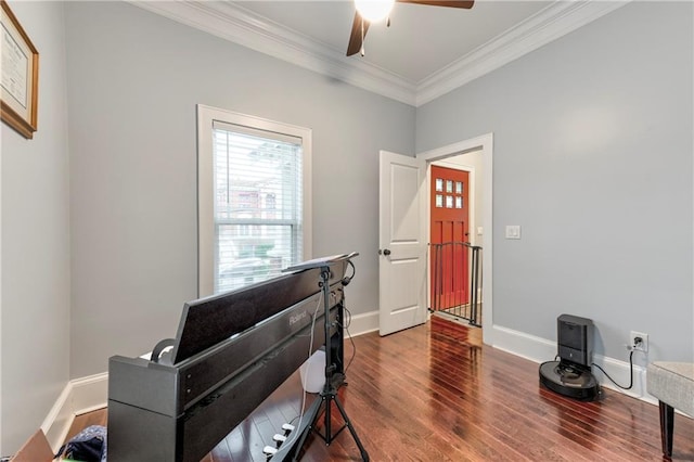 interior space featuring ornamental molding, dark wood-type flooring, and ceiling fan