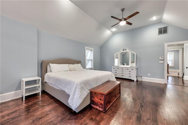 bedroom with multiple windows, vaulted ceiling, dark hardwood / wood-style flooring, and ceiling fan