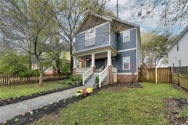 view of front facade with a front yard and covered porch