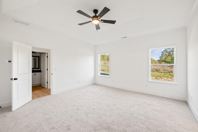 unfurnished bedroom featuring light carpet, visible vents, and baseboards