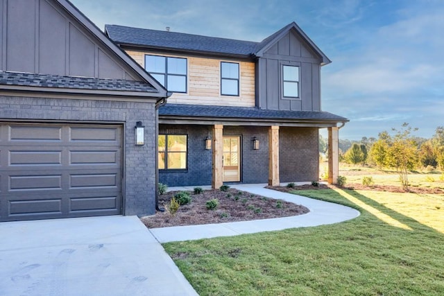 view of front facade with a shingled roof, an attached garage, a front lawn, board and batten siding, and brick siding