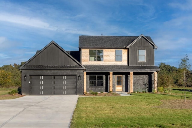 view of front of house with board and batten siding, a front yard, driveway, and an attached garage