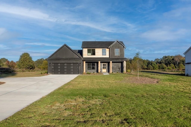 traditional-style house with a garage, driveway, and a front lawn