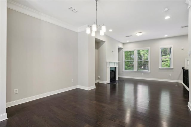 unfurnished living room with wood finished floors, a high end fireplace, recessed lighting, baseboards, and a chandelier