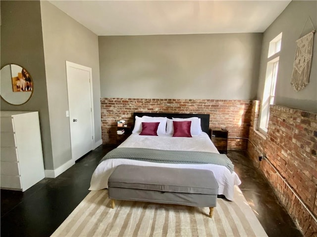 bedroom featuring brick wall