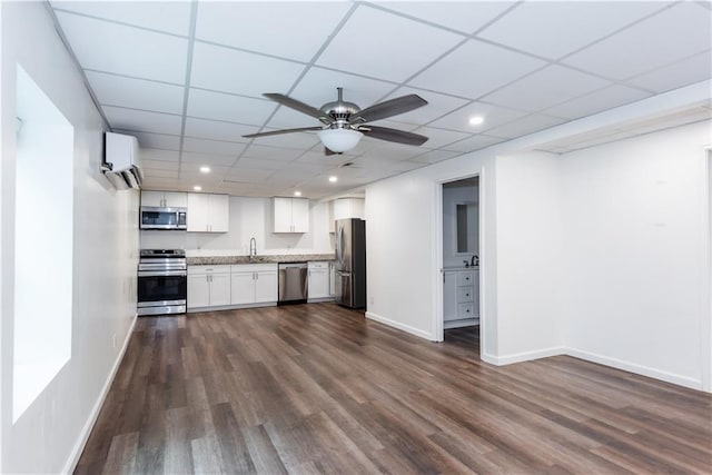 3336 Forrest Hills Dr, Hapeville, GA 30354 - kitchen featuring appliances with stainless steel finishes, a wall mounted AC, dark wood-type flooring, white cabinets, and recessed lighting