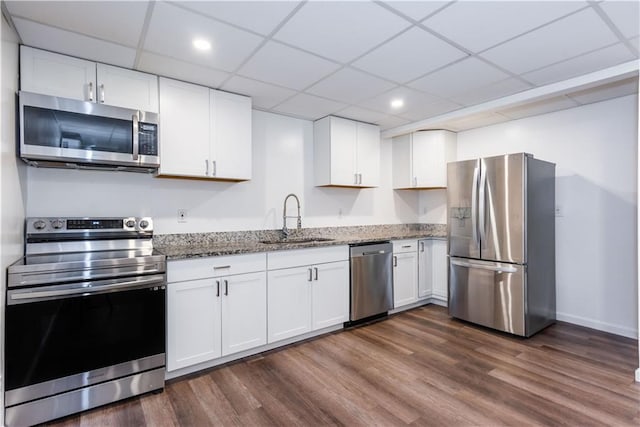 3336 Forrest Hills Dr, Hapeville, GA 30354 - kitchen featuring appliances with stainless steel finishes, stone countertops, white cabinetry, dark wood finished floors, and a drop ceiling