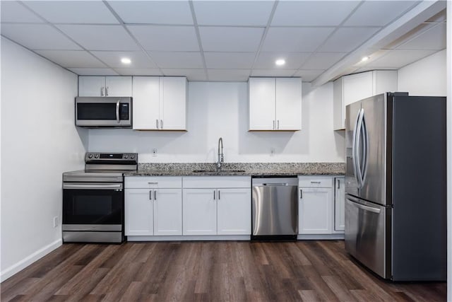 3336 Forrest Hills Dr, Hapeville, GA 30354 - kitchen featuring appliances with stainless steel finishes, white cabinets, dark wood-style floors, dark stone countertops, and a paneled ceiling
