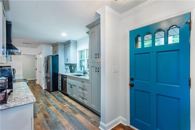 3336 Forrest Hills Dr, Hapeville, GA 30354 - kitchen featuring freestanding refrigerator, dishwasher, wall chimney range hood, dark wood-type flooring, and ornamental molding