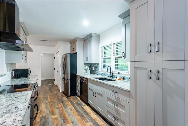 3336 Forrest Hills Dr, Hapeville, GA 30354 - kitchen featuring wall chimney range hood, appliances with stainless steel finishes, crown molding, tasteful backsplash, and dark wood-style flooring