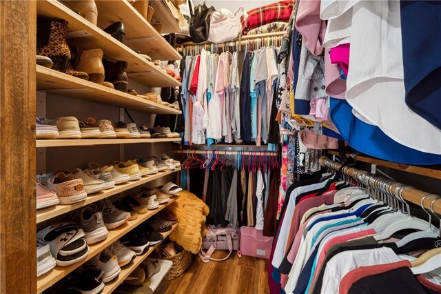 walk in closet with hardwood / wood-style floors