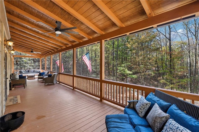 wooden terrace with an outdoor living space and ceiling fan