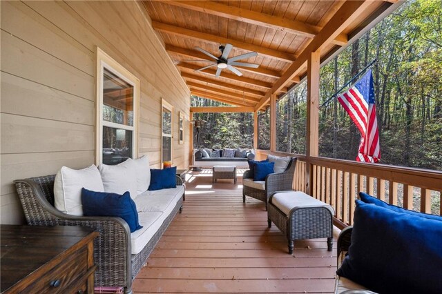 wooden deck with an outdoor living space and ceiling fan