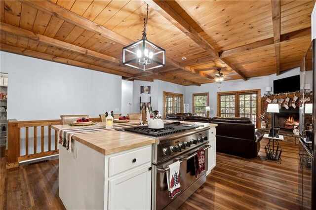 kitchen featuring wood counters, pendant lighting, range with two ovens, dark hardwood / wood-style floors, and white cabinetry