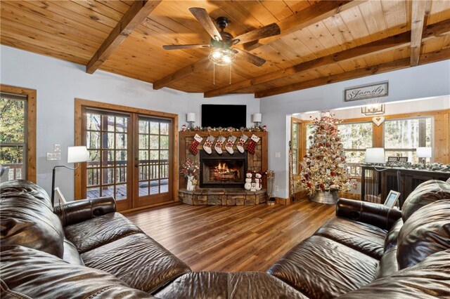 living room featuring hardwood / wood-style flooring, a healthy amount of sunlight, wood ceiling, and beamed ceiling