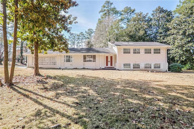 rear view of property with a yard