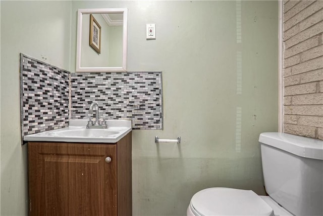 bathroom featuring tasteful backsplash, vanity, and toilet