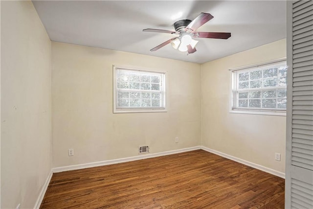 spare room featuring dark hardwood / wood-style floors and ceiling fan