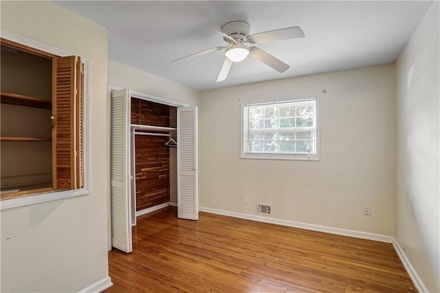 unfurnished bedroom featuring light hardwood / wood-style floors, a closet, and ceiling fan