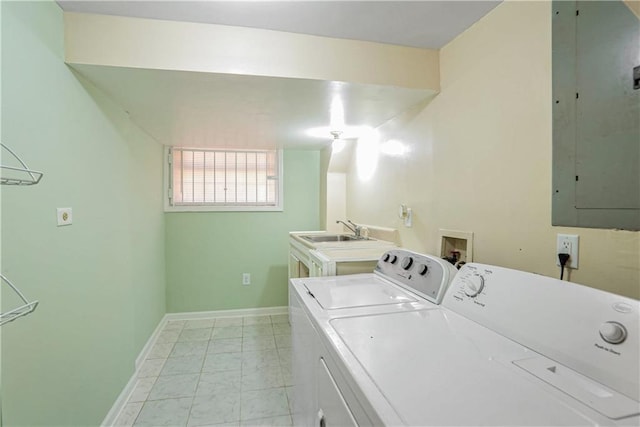 laundry area with electric panel, sink, and washer and dryer