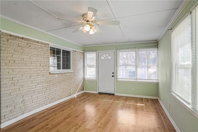 unfurnished sunroom with ceiling fan