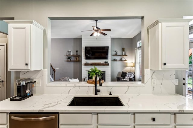 kitchen with white cabinets, ceiling fan, a sink, and dishwasher