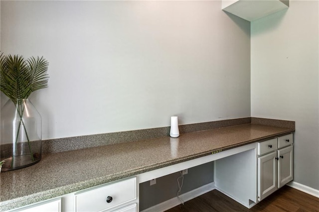 details featuring built in study area and wood finished floors