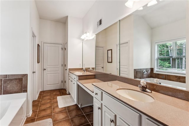 bathroom featuring double vanity, a sink, and a bath