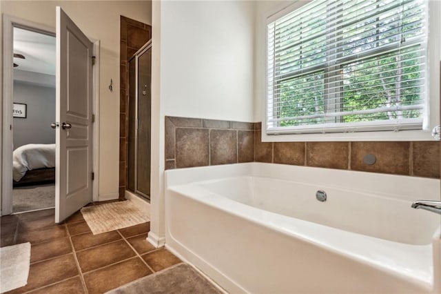 full bathroom with tile patterned floors, a shower stall, ensuite bathroom, and a garden tub