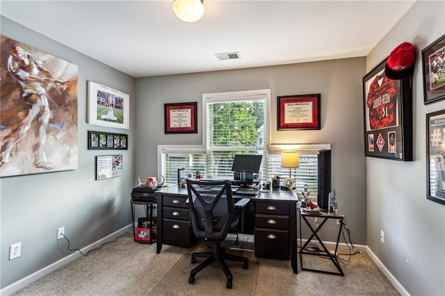 carpeted office with visible vents and baseboards