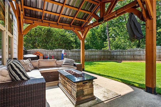 view of patio / terrace featuring a fenced backyard and an outdoor living space with a fire pit