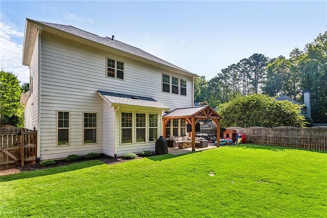 rear view of house featuring an outdoor hangout area, a gazebo, a yard, and a fenced backyard