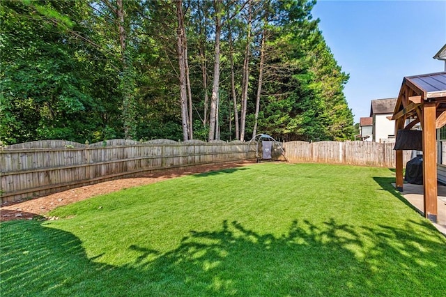 view of yard with a fenced backyard
