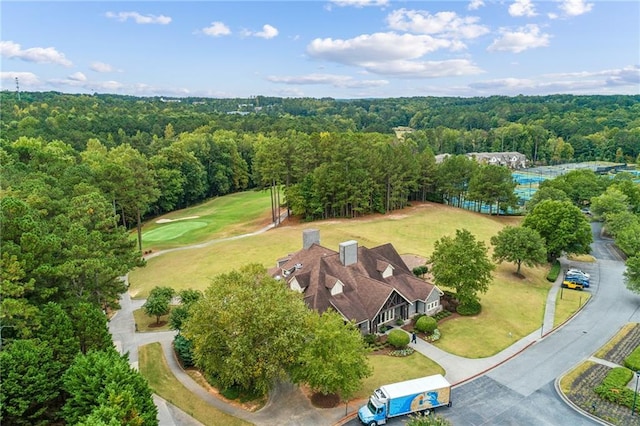 birds eye view of property featuring a forest view
