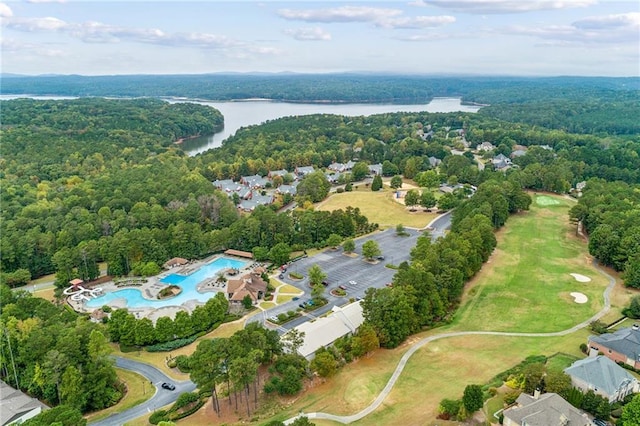 birds eye view of property featuring a water view and a view of trees