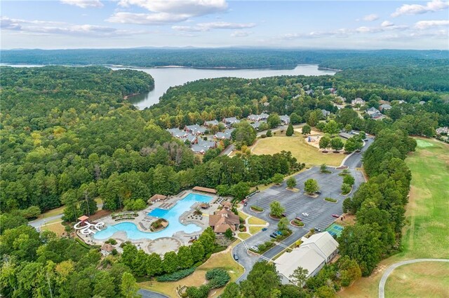 aerial view with a water view and a forest view