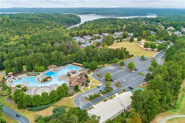 aerial view with a water view and a wooded view