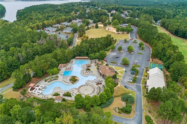 drone / aerial view with a water view and a wooded view