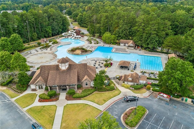 birds eye view of property featuring a wooded view