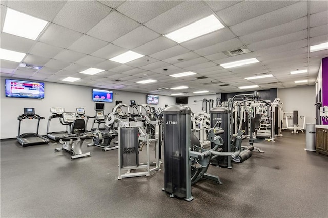 gym featuring visible vents and a paneled ceiling