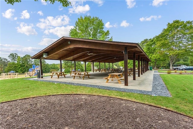 view of community with a lawn, fence, and a gazebo
