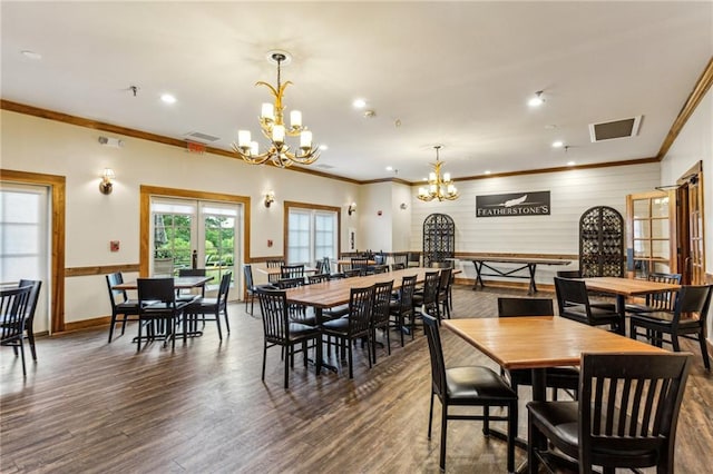 dining room featuring crown molding, a notable chandelier, dark wood finished floors, and visible vents