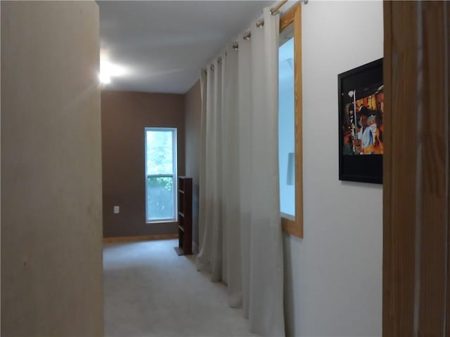 hallway with light colored carpet