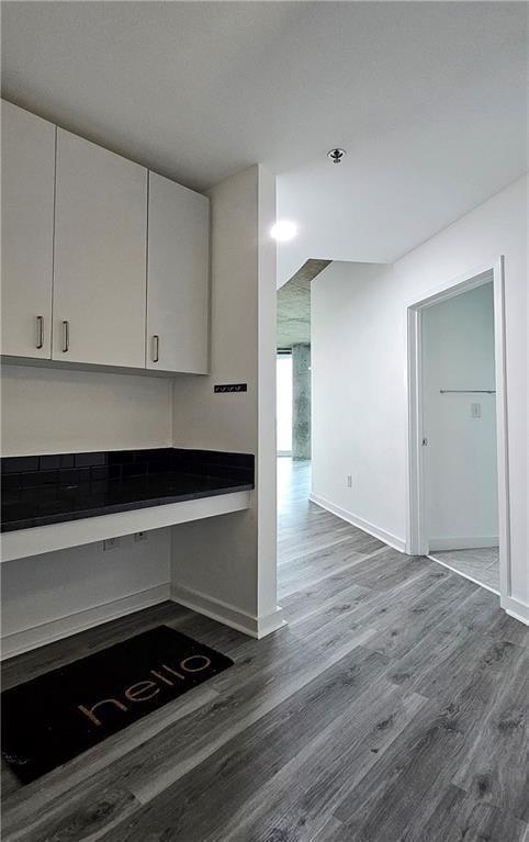 kitchen featuring hardwood / wood-style floors and white cabinets