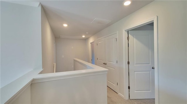 corridor featuring recessed lighting, light carpet, attic access, and an upstairs landing