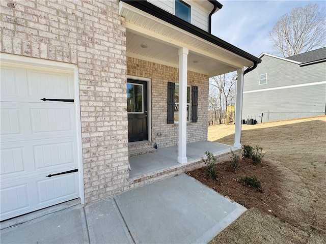 view of patio featuring a garage and a porch