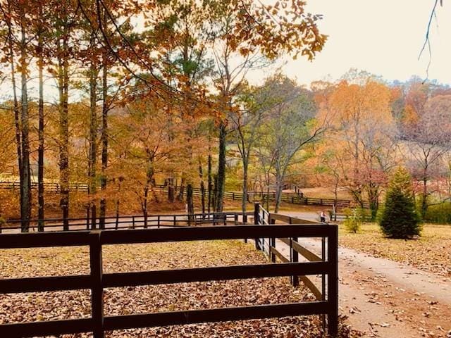 view of home's community featuring fence