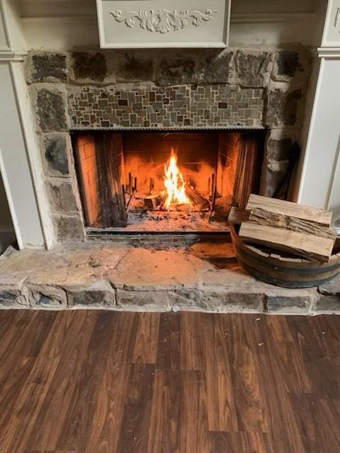 detailed view of wood finished floors and a tile fireplace
